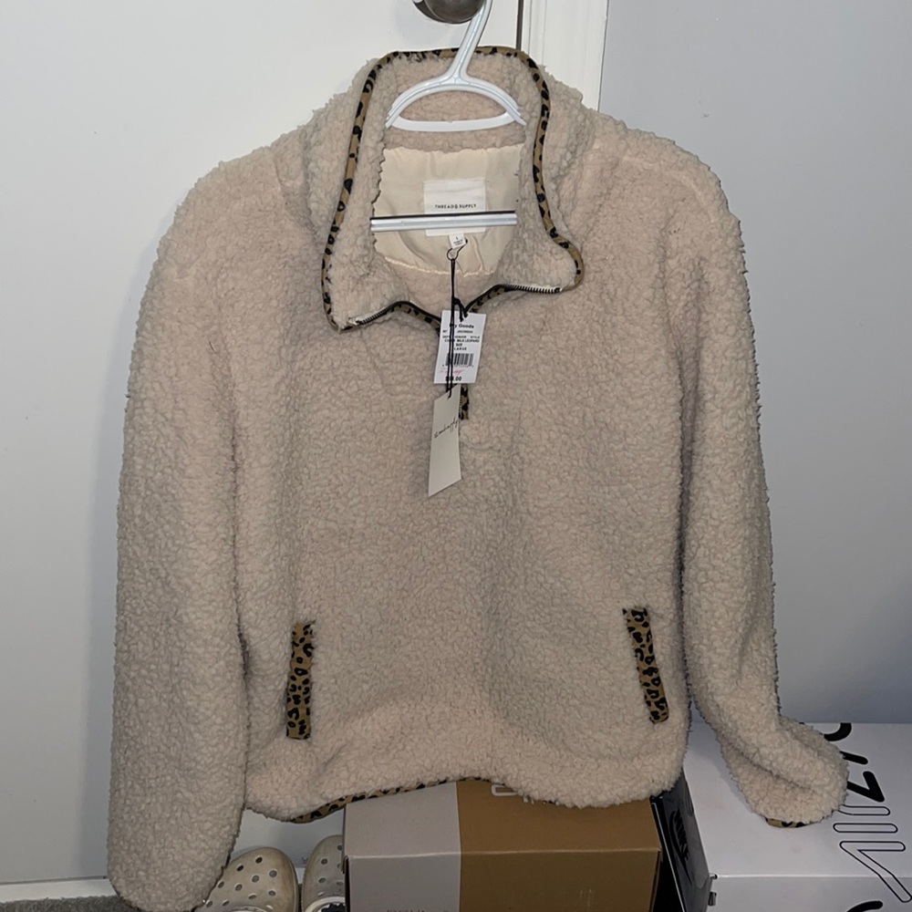 sherpa pullover half zip, cheetah print outline.